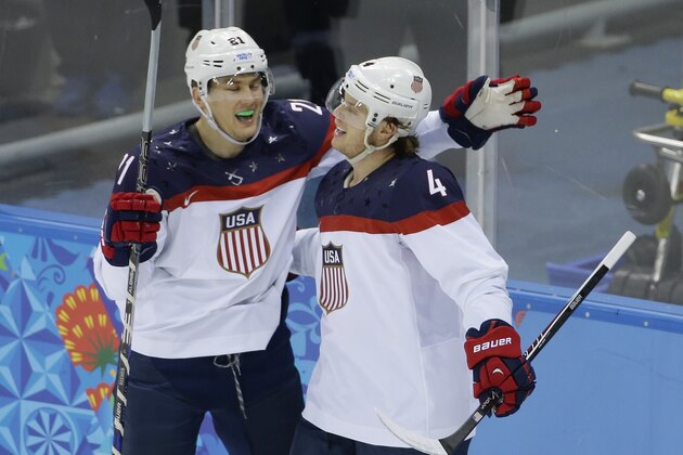 USA defenseman John Carlson, right, is congratulated for his goal against Slovakia by USA forward James van Riemsdyk during the 2014 Winter Olympics men's ice hockey game at Shayba Arena, Thursday, Feb. 13, 2014, in Sochi, Russia. (AP Photo/Matt Slocum)