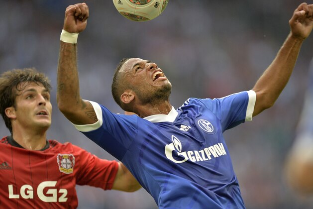 Schalke's new player Dennis Aogo, right, and Leverkusen's Giulio Donati of Italy challenge for the ball during the German soccer Bundesliga match between FC Schalke 04 and Bayer Leverkusen at the arena in Gelsenkirchen, Germany, Saturday, Aug. 31, 2013. (AP Photo/Martin Meissner)