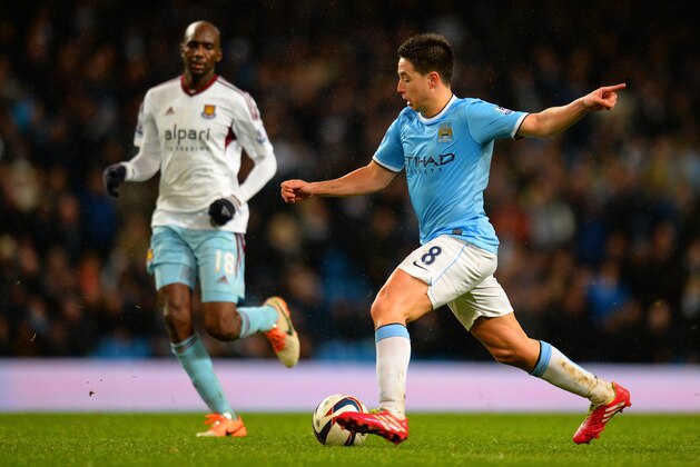 MANCHESTER, ENGLAND - JANUARY 08: Samir Nasri of Manchester City runs with the ball during the Capital One Cup Semi-Final first leg match between Manchester City and West Ham United at Etihad Stadium on January 8, 2014 in Manchester, England.  (Photo by Shaun Botterill/Getty Images)