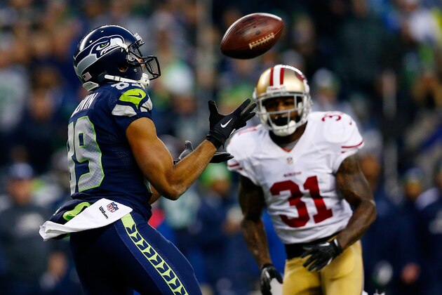 SEATTLE, WA - JANUARY 19: Wide receiver Doug Baldwin #89 of the Seattle Seahawks catches the ball as strong safety Donte Whitner #31 of the San Francisco 49ers defends during the 2014 NFC Championship at CenturyLink Field on January 19, 2014 in Seattle, Washington.  (Photo by Tom Pennington/Getty Images)