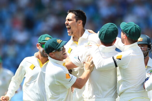 Australia's bowler Mitchell Johnson, center, celebrates with teammates after dismissing South Africa's captain Graeme Smith, for 10 runs on the second day of their their cricket test match at Centurion Park in Pretoria, South Africa, Thursday, Feb. 13, 2014. (AP Photo/ Themba Hadebe)
