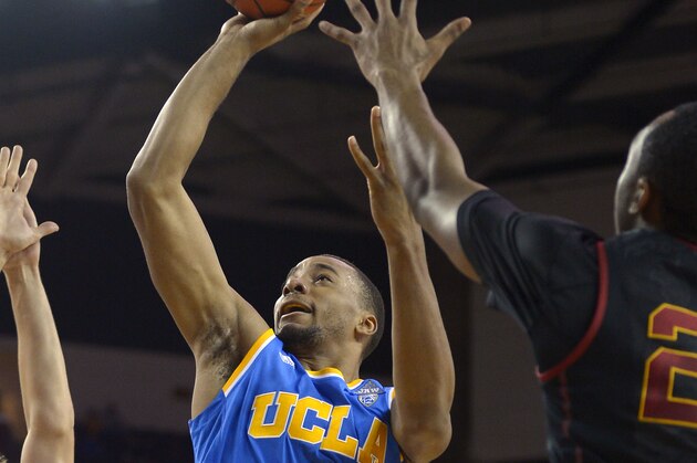 UCLA guard Norman Powell, center, puts up a shots as Southern California forward Nikola Jovanovic, left, center Omar Oraby, second from left, and guard Byron Wesley defend during the first half of an NCAA college basketball game, Saturday, Feb. 8, 2014, in Los Angeles. (AP Photo/Mark J. Terrill)