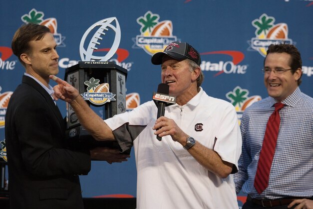 Jan 1, 2014; Orlando, FL, USA; South Carolina Gamecocks head coach Steve Spurrier accepts a trophy after defeating the Wisconsin Badgers in the Capital One Bowl held at the Florida Citrus Bowl. Mandatory Credit: Rob Foldy-USA TODAY Sports