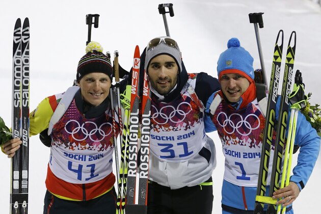 France's gold medal winner Martin Fourcade is flanked by Germany's silver medal winner Erik Lesser, left, and Russia's bronze medal winner Yevgeny Garanichev after the flower ceremony of the men's biathlon 20k individual race, at the 2014 Winter Olympics, Thursday, Feb. 13, 2014, in Krasnaya Polyana, Russia. (AP Photo/Kirsty Wigglesworth)