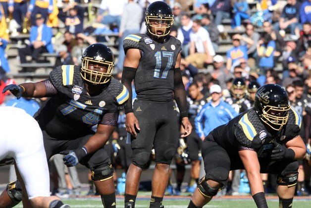 UCLA quarterback Brett Hundley gets set behind the line of scrimmage against Virginia Tech during the Sun Bowl NCAA college football game Tuesday Dec. 31, 2013. (AP Photo/Victor Calzada)
