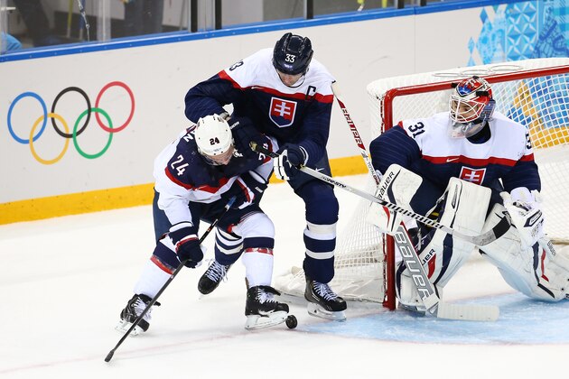 SOCHI, RUSSIA - FEBRUARY 13:  Ryan Callahan #24 of United States and Zdeno Chara #33 of Slovakia battle for the puck during the Men's Ice Hockey Preliminary Round Group A game on day six of the Sochi 2014 Winter Olympics at Shayba Arena on February 13, 2014 in Sochi, Russia.  (Photo by Streeter Lecka/Getty Images)