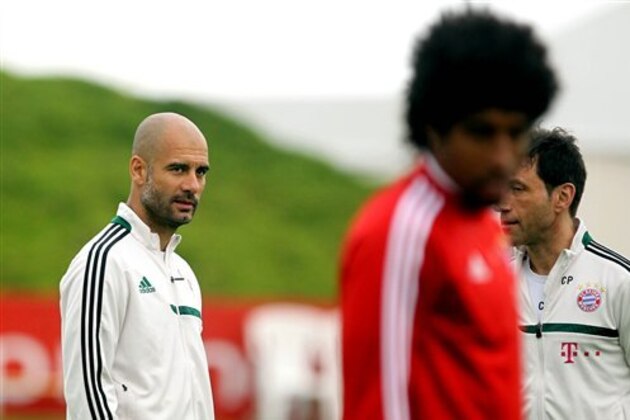 Bayern Munich's head coach Pep Guardiola, left, attends a training session at the ASPIRE Academy for Sports Excellence in Doha, Qatar, Monday, Jan. 6, 2013. (AP Photo/Osama Faisal)