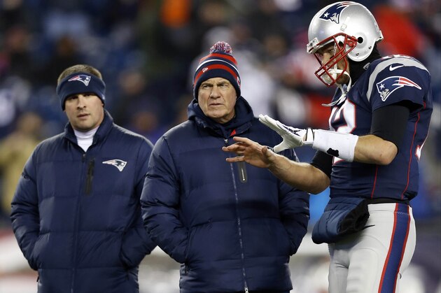 Nov 24, 2013; Foxborough, MA, USA; New England Patriots quarterback Tom Brady (12) talks with head coach Bill Belichick (middle) and offensive coordinator Josh McDaniels  during warm-ups before the game against the Denver Broncos at Gillette Stadium Stadium. Mandatory Credit: Greg M. Cooper-USA TODAY Sports