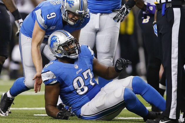 In this Dec. 16, 2013, photo, Detroit Lions quarterback Matthew Stafford (9) checks on tight end Brandon Pettigrew (87) after Pettigrew was injured during an NFL football game against the Baltimore Ravens in Detroit. The Lions have placed Pettigrew on injured reserve, ending his season. (AP Photo/Rick Osentoski)