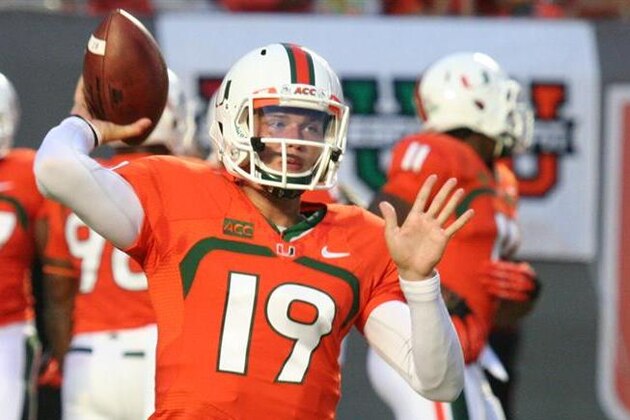 Miami quarterbacks Stephen Morris (17) and Kevin Olsen (19) celebrate after a Miami TD during the first half of a NCAA college football game  against Florida in Miami Gardens, Fla., Saturday, Sept. 7, 2013. (AP Photo/J Pat Carter)