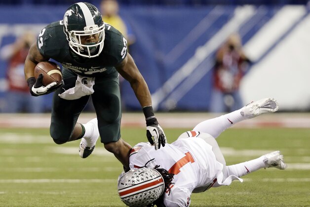Michigan State's Jeremy Langford, left, is tackled by Ohio State's Bradley Roby (1) during the first half of a Big Ten Conference championship NCAA college football game Saturday, Dec. 7, 2013, in Indianapolis. (AP Photo/Darron Cummings)
