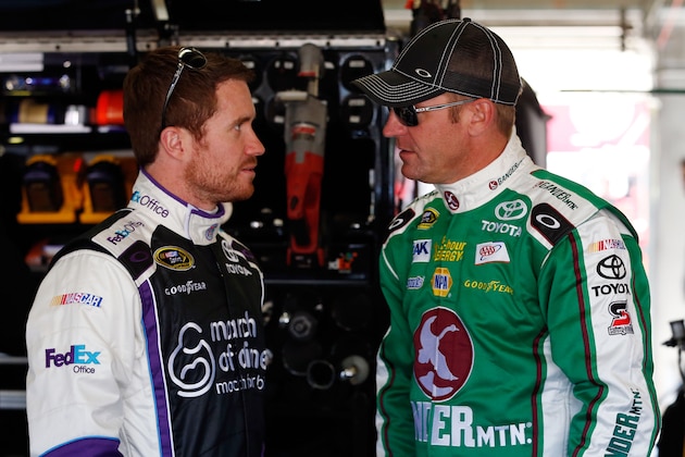 FORT WORTH, TX - APRIL 11:  Brian Vickers, driver of the #11 FedEx Office/March of Dimes Toyota, talks to Clint Bowyer, driver of the #15 Gander Mountain Toyota, in the garage area during NASCAR Sprint Cup Series Gen-6 Testing at Texas Motor Speedway on April 11, 2013 in Fort Worth, Texas.  (Photo by Chris Graythen/Getty Images for Texas Motor Speedway)