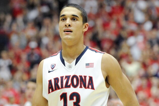 Jan 26, 2014; Tucson, AZ, USA; Arizona Wildcats guard Nick Johnson (13) runs down the court during the second half against the Utah Utes at McKale Center. Arizona won 65-56. Mandatory Credit: Casey Sapio-USA TODAY Sports