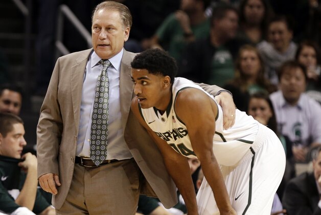 Michigan State head coach Tom Izzo, left, talks to Gary Harris during the first half of a Coaches vs. Cancer NCAA college basketball game against Virginia Tech, Friday, Nov. 22, 2013, in New York. (AP Photo/Frank Franklin II)