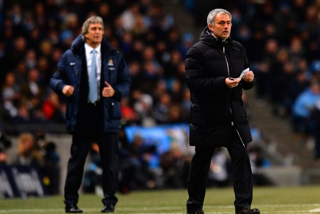 MANCHESTER, ENGLAND - FEBRUARY 03: Manuel Pellegrini manager of Manchester City and Jose Mourinho manager of Chelsea give instructions during the Barclays Premier League match between Manchester City and Chelsea at Etihad Stadium on February 3, 2014 in Manchester, England.  (Photo by Shaun Botterill/Getty Images)