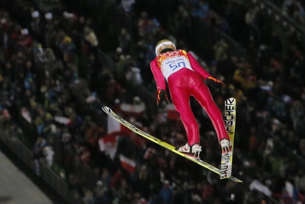 Poland's gold medal winner Kamil Stoch makes his second attempt during the men's normal hill ski jumping final at the 2014 Winter Olympics, Sunday, Feb. 9, 2014, in Krasnaya Polyana, Russia. (AP Photo/Dmitry Lovetsky)