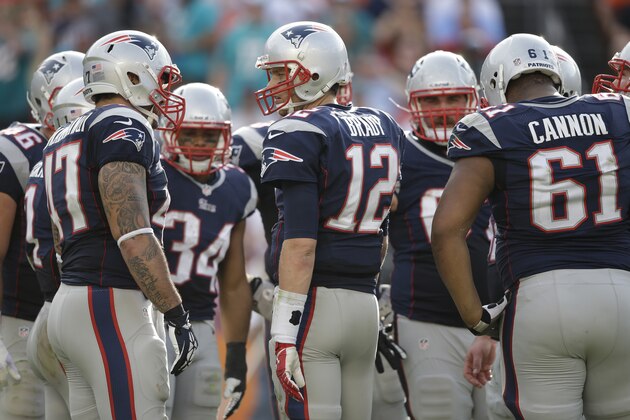 New England Patriots quarterback Tom Brady (12) talks to the offensive line during the second half of an NFL football game against the Miami Dolphins, Sunday, Dec. 15, 2013, in Miami Gardens, Fla. (AP Photo/Lynne Sladky)