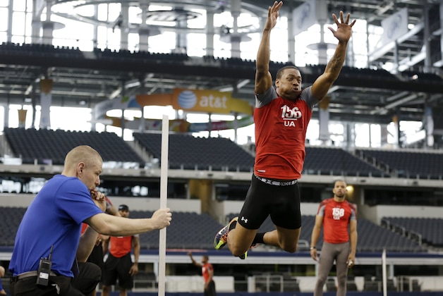 Combine staff member Mike Kozak, left, watches wide receiver Samie Parker (156) leap during the broad jump drill during the NFL super regional football scouting combine, Monday, April 8, 2013, in Arlington, Texas. (AP Photo/Tony Gutierrez) Combine staff member Mike Kozak, left, watches wide receiver Samie Parker (156) leap during the broad jump drill during the NFL super regional football scouting combine, Monday, April 8, 2013, in Arlington, Texas. (AP Photo/Tony Gutierrez)