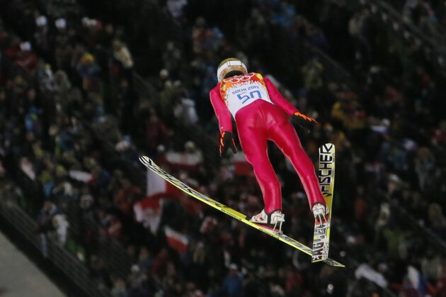 Poland's gold medal winner Kamil Stoch makes his second attempt during the men's normal hill ski jumping final at the 2014 Winter Olympics, Sunday, Feb. 9, 2014, in Krasnaya Polyana, Russia. (AP Photo/Dmitry Lovetsky)