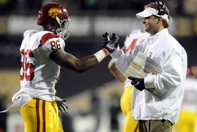 USC tight end Xavier Grimble (86) celebrates a touchdown with head coach Lane Kiffin during the first half of an NCAA football game against Colorado in Boulder, Colo., Friday, Nov. 4, 2011. (AP Photo/Jack Dempsey)