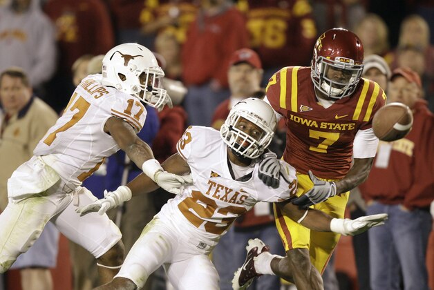 Texas cornerback Carrington Byndom (23) and cornerback Adrian Phillips (17) break up a pass intended for Iowa State wide receiver Darius Reynolds (7) during the second half of an NCAA college football game, Saturday, Oct. 1, 2011, in Ames, Iowa. Texas won 37-14.  (AP Photo/Charlie Neibergall)
