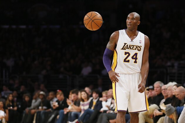 Los Angeles Lakers' Kobe Bryant allows the ball to bounce freely in front of him as he controls the ball against the Toronto Raptors during the first half of an NBA basketball game in Los Angeles, Sunday, Dec. 8, 2013. It was Bryant's first game back after a torn left Achilles tendon injury on April 12th and the Raptors won 106-94. (AP Photo/Danny Moloshok)