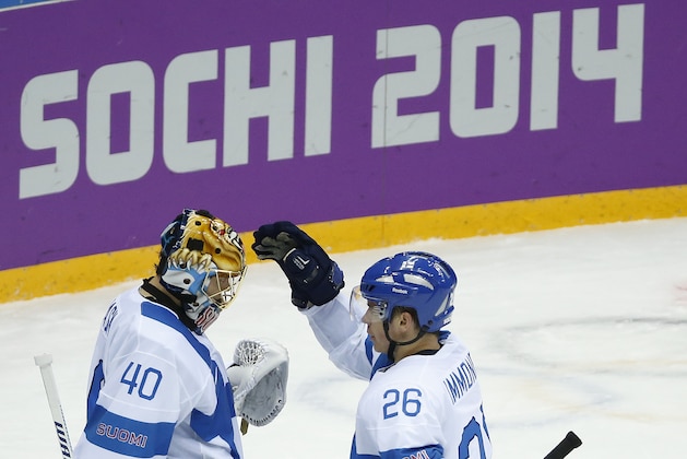Finland's Jarkko Immonen (26) congratulates Finland goaltender Tuukka Rask after Finland beat Austria 8-4 in a men's ice hockey game at the 2014 Winter Olympics, Thursday, Feb. 13, 2014, in Sochi, Russia. (AP Photo/Mark Humphrey)