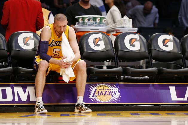 Los Angeles Lakers' Steve Blake sits along on the bench with a towel in his mouth after the Lakers lost to the Utah Jazz 96-79 in an NBA basketball game in Los Angeles, Tuesday, Feb. 11, 2014. (AP Photo/Danny Moloshok)