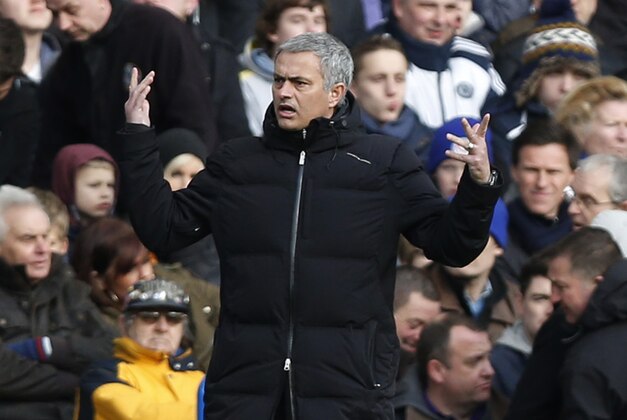 Chelsea's manager Jose Mourinho raises his arms as he watches his team play against Newcastle United during their English Premier League soccer match at Stamford Bridge, London, Saturday, Feb. 8, 2014. (AP Photo/Sang Tan)
