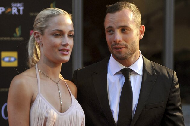 This Nov. 4, 2012 photo shows Oscar Pistorius and girlfriend Reeva Steenkamp at an awards ceremony in Johannesburg, South Africa. A lawyer for the family of Oscar Pistorius' slain girlfriend  said Tuesday Aug. 20 2013, that representatives of the two families were in contact, possibly over an out-of-court settlement that would compensate  Steenkamp's parents for her killing by the double-amputee Olympian, Pistorius.  (AP Photo/City Press, Lucky Nxumalo) SOUTH AFRICA OUT