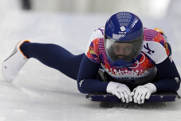 Elizabeth Yarnold of Great Britain brakes in the finish area after her first run during the women's skeleton competition at the 2014 Winter Olympics, Thursday, Feb. 13, 2014, in Krasnaya Polyana, Russia. (AP Photo/Natacha Pisarenko)