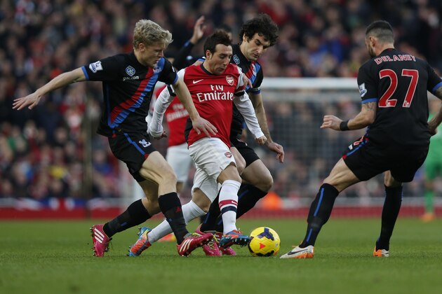 Arsenal's Santi Cazorla, second left, competes with Crystal Palace's Jonathan Parr, left, Mile Jedinak, third left, and Damien Delaney during their English Premier League soccer match at Emirates Stadium in London, Sunday, Feb. 2, 2014. (AP Photo/Sang Tan)