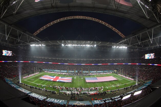 In this image taken with a fish eye lens the British Union flag and the Stars and Stripes are unfurled on the field ahead of the NFL football game between San Francisco 49ers and Jacksonville Jaguars at Wembley Stadium in London, Sunday, Oct. 27, 2013. (AP Photo/Nicky Hayes, NFL UK)