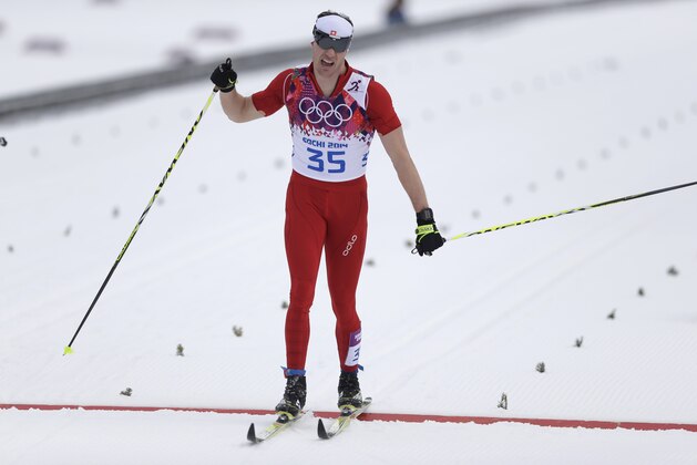 Switzerland's Dario Cologna crosses the finish line of the men's 15K classical-style cross-country race at the 2014 Winter Olympics, Friday, Feb. 14, 2014, in Krasnaya Polyana, Russia. (AP Photo/Matthias Schrader)