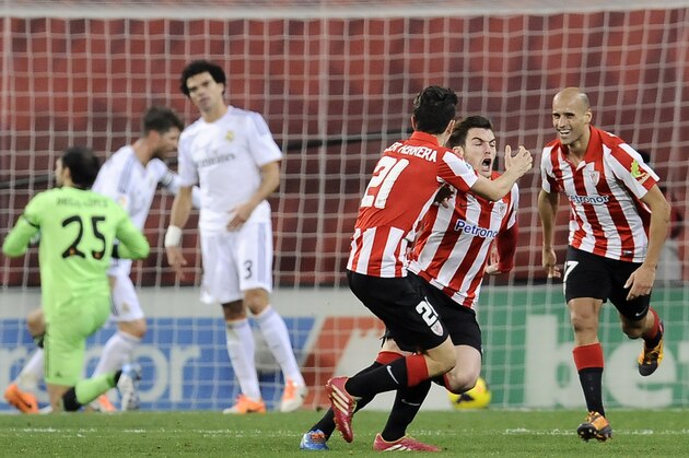Athletic Bilbao's Ibai Gomez, second right,  celebrates between his teammates Mikel Rico, right, and Ander Herrera, center,  after scoring his goal resulting in a tie, during the Spanish League soccer match between Athletic Bilbao and Real Madrid, at San Mames stadium in Bilbao, Spain, Sunday, Feb. 2, 2014. (AP Photo/Alvaro Barrientos)