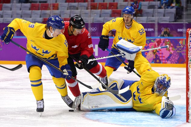 SOCHI, RUSSIA - FEBRUARY 14: ss30 makes a save against Nino Niederreiter #22 of Switzerland as Nicklas Backstrom #19 defends during the Men's Ice Hockey Preliminary Round Group C game on day seven of the Sochi 2014 Winter Olympics at Bolshoy Ice Dome on February 14, 2014 in Sochi, Russia.  (Photo by Martin Rose/Getty Images)
