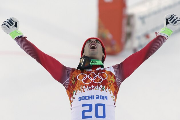 Men's supercombined gold medal winner Switzerland's Sandro Viletta celebrates on the podium during a flower ceremony at the Sochi 2014 Winter Olympics, Friday, Feb. 14, 2014, in Krasnaya Polyana, Russia. (AP Photo/Christophe Ena)