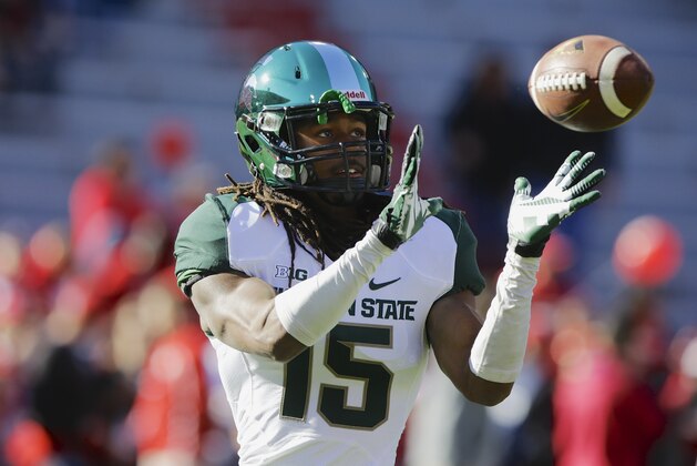 Michigan cornerback Trae Waynes (15) catches the ball during warmups as Michigan State and Nebraska prepare to square off in an NCAA college football game in Lincoln, Neb., Saturday, Nov. 16, 2013. (AP Photo/Nati Harnik)