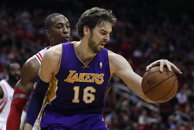 Jan 8, 2014; Houston, TX, USA; Los Angeles Lakers center Pau Gasol (16) is defended by Houston Rockets power forward Dwight Howard (12) during the fourth quarter at Toyota Center. Mandatory Credit: Andrew Richardson-USA TODAY Sports