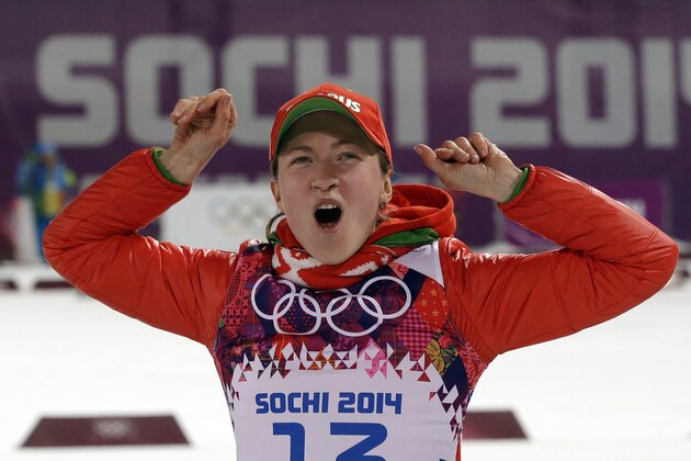 Belarus' Darya Domracheva celebrates winning the gold medal in the women's biathlon 15k individual race, at the 2014 Winter Olympics, Friday, Feb. 14, 2014, in Krasnaya Polyana, Russia. (AP Photo/Lee Jin-man)