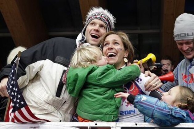 ADDS ID OF MAN AT LEFT - Noelle Pikus-Pace of the United States celebrates with her brother Jared Pikus, left, husband, Janson Pace, far right, and children, Traycen, left, and Lacee, right, after she won the silver medal during the women's skeleton competition at the 2014 Winter Olympics, Friday, Feb. 14, 2014, in Krasnaya Polyana, Russia. (AP Photo/Michael Sohn)