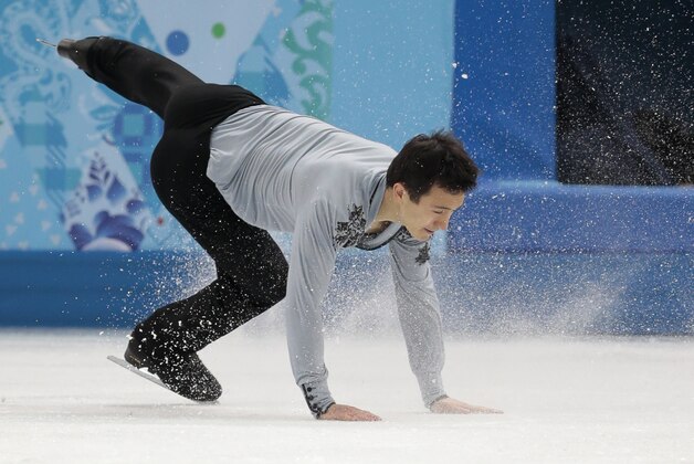 Patrick Chan of Canada falls as he competes in the men's free skate figure skating final at the Iceberg Skating Palace during the 2014 Winter Olympics, Friday, Feb. 14, 2014, in Sochi, Russia. (AP Photo/Ivan Sekretarev)