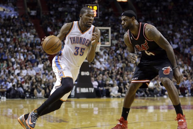 Oklahoma City Thunder small forward Kevin Durant (35) drives against Miami Heat small forward LeBron James (6) during the fourth quarter of an NBA basketball game in Miami, Wednesday, Jan. 29, 2014. The Thunder won 112-95. (AP PhotoAlan Diaz)