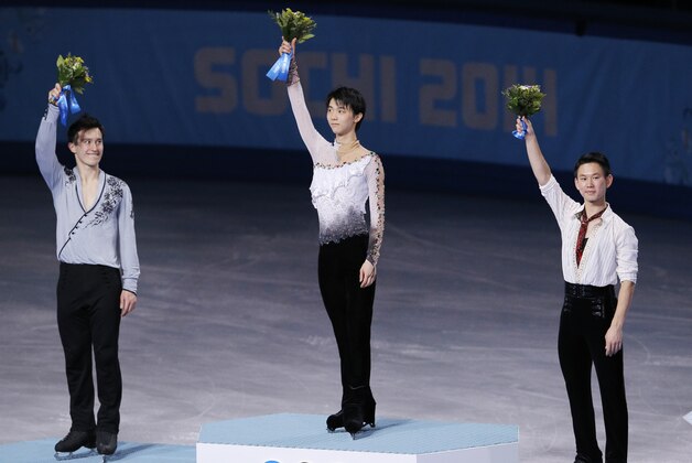 Yuzuru Hanyu of Japan, centre, Patrick Chan of Canada, left, and Denis Ten of Kazakhstan stand on the podium during the flower ceremony for the men's free skate figure skating final at the Iceberg Skating Palace during the 2014 Winter Olympics, Friday, Feb. 14, 2014, in Sochi, Russia. Hanyu placed first, Chan second and Ten third. (AP Photo/Vadim Ghirda)