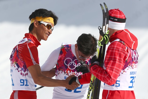 SOCHI, RUSSIA - FEBRUARY 14: Gold medalist Dario Cologna (R) of Switzerland applauds Dachhiri Sherpa (L) of Nepal and Roberto Carcelen (C) of Peru after competing in the Men's 15 km Classic during day seven of the Sochi 2014 Winter Olympics at Laura Cross-country Ski & Biathlon Center on February 14, 2014 in Sochi, Russia.  (Photo by Paul Gilham/Getty Images)