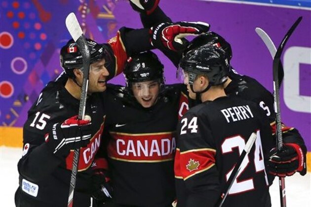 Team Canada celebrates a first period goal against Austria during a men's ice hockey game at the 2014 Winter Olympics, Friday, Feb. 14, 2014, in Sochi, Russia. (AP Photo/Julio Cortez)