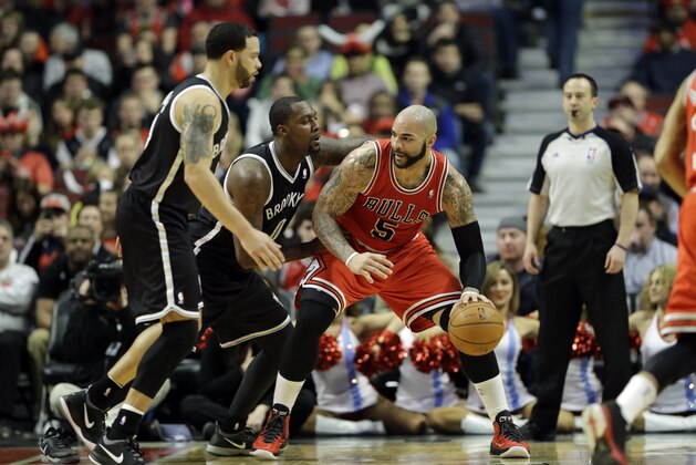 Chicago Bulls forward Carlos Boozer, right, drives against the Brooklyn Nets during the first half of an NBA basketball game in Chicago on Thursday, Feb. 13, 2014. (AP Photo/Nam Y. Huh)