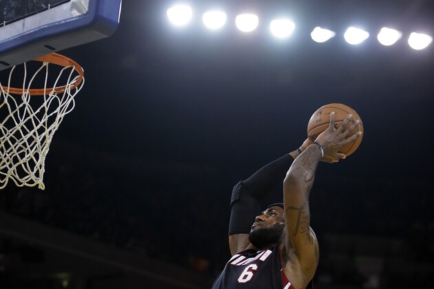 Miami Heat's LeBron James lays up a shot against the Golden State Warriors during the first half of an NBA basketball game on Wednesday, Feb. 12, 2014, in Oakland, Calif. (AP Photo/Ben Margot)
