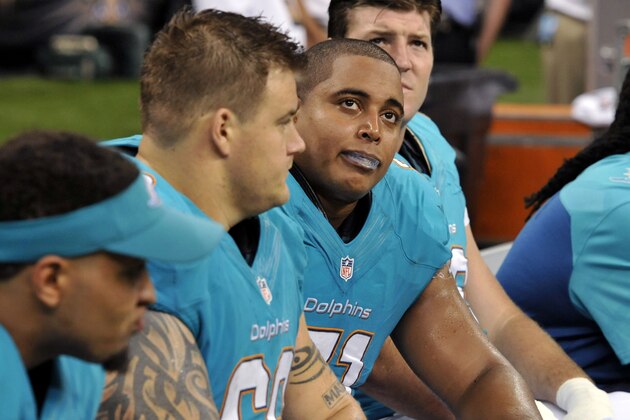 FILE - In this Sept. 30, 2013 file photo, Miami Dolphins guard Richie Incognito (68), center left, and  and tackle Jonathan Martin (71), center right, sit on the bench in the second half of an NFL football game against the New Orleans Saints in New Orleans. About halfway between the start of exhibition games and the Super Bowl, there have been plenty of unwanted story lines. Bullying in the locker room, coaches collapsing, serious injuries to marquee players, the D.C. Council's call on Washington's pro football team to change its name _ examples from the past week alone. (AP Photo/Bill Feig, File)