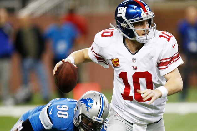 DETROIT, MI - DECEMBER 22: Eli Manning #10 of the New York Giants escapes the rush of Nick Fairley #98 of the Detroit Lions during the fourth quarter at Ford Field on December 22, 2013 in Detroit, Michigan. New York won the game in overtime 23-20. (Photo by Gregory Shamus/Getty Images)